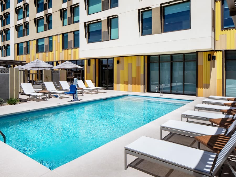 Outdoor pool, open 7:00 AM to 10:00 PM, pool loungers