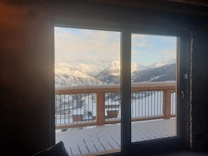 A room with a large window overlooking a snowy mountain landscape. - SKI IN SKI OUT PARADISKI LA PLAGNE LES COCHES TOP OF THE RANGE CHALET (Bellentre)