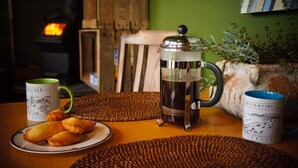 A table with a coffee press, two mugs, and a plate of pastries. - The Bolt Hole (Saint Merryn)