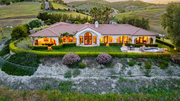A large, single-story house with a tiled roof, multiple windows, and a well-maintained lawn. - Luxe Ranch with Hot Tub, Gourmet Kitchen and Fabulous Downtown Views. (Paso Robles)