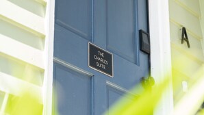 A blue door with a sign that reads "The Charles Suite."