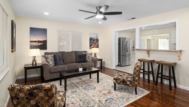 A living room with a sofa, coffee table, patterned rug, and two patterned chairs. - Upgraded 3B/2Bth w DinningR on Peaceful Street (Fresno)