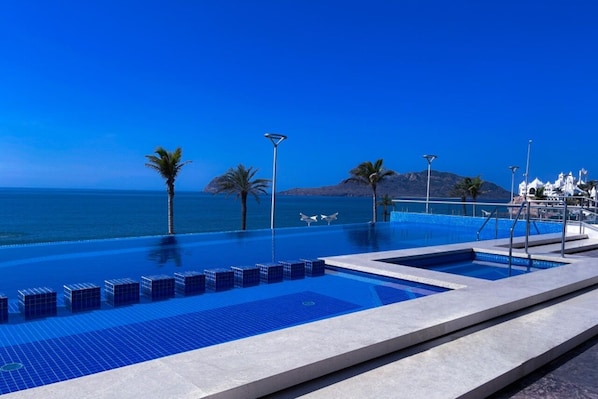 Outdoor pool, pool umbrellas, pool loungers