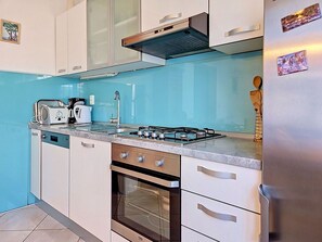 A kitchen with a gas stove, oven, and a dishwasher.