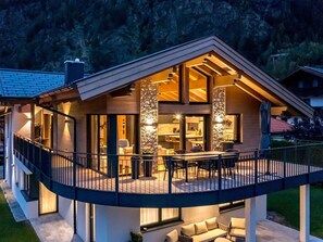 Enjoy a peaceful retreat with a balcony and seating area overlooking a serene natural setting.