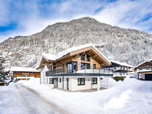 Enjoy breathtaking views of the snow-covered mountains from the balcony of this ski resort.