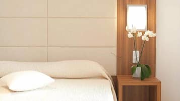 A bedroom with a bed, a nightstand with a vase of flowers, and a wooden headboard.