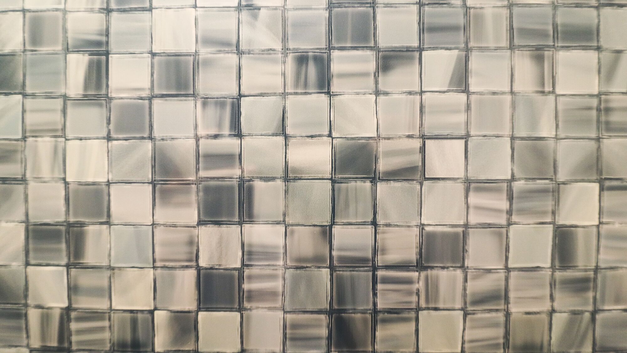 A tiled wall with a grid pattern.