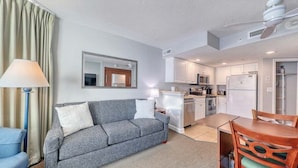 A compact living space with a sofa, a dining table, and a kitchenette. - HS-1017 Ocean View Retreat on the 10th Floor in Myrtle Beach, Sleeps 6 (Myrtle Beach)