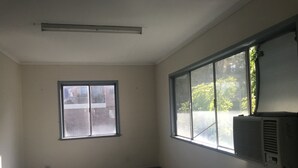 A room with a large window, a ceiling vent, and an air conditioning unit. - Camping with a Roof, bathroom and Kitchen (Palm Beach)