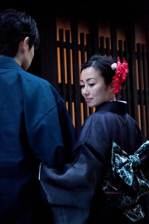 A person in traditional attire with a floral accessory. - Yamagata Kyomachi Hatago Gojo Nishitoin (Kyoto)
