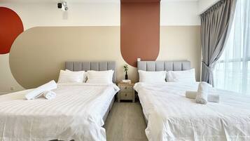 A hotel room with two beds, a nightstand, a vase with a plant, and a large window with curtains.