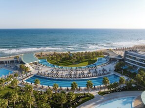 A resort with a large pool, palm trees, and a beach view. - Lyttos Mare Adults Friendly 12+ (Hersonissos)