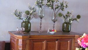 A wooden cabinet with three glass vases containing flowers. - Regenta Resort & Spa Mashobra (Shimla)