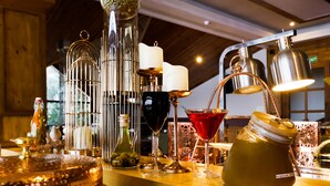 A bar area with various bottles, glasses, and a candle. - Regenta Resort & Spa Mashobra (Shimla)