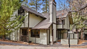 A two-story house with a gabled roof and a chimney. - Snow Summit Chalet by Destination Big Bear : Next Door to Snow Summit for Easy Access to Skiing, Snowboarding and Tubing! (Big Bear Lake)