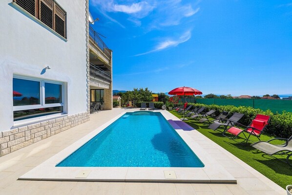 A heated pool, pool loungers