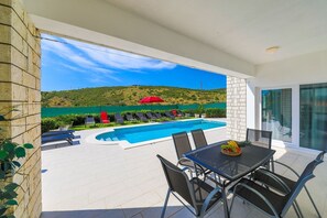 A heated pool, sun loungers