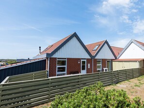 A row of modern, single-story buildings with pitched roofs, likely part of a caravan or camping site. - 6 Person Holiday Home in Hvide Sande (Hvide Sande)