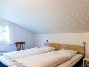 A room with a bed, a chair, and a window. - 4 Star Holiday Home in Henne (Henne)