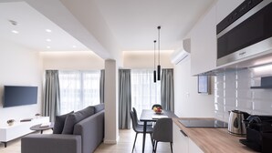 A modern apartment with a living area, dining space, and kitchen. - Hestia - Ippokratous 35 (Athens)