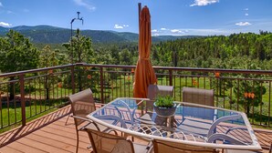 A balcony with a glass table, chairs, and a potted plant. - Luxury Million Dollar Mountain Views: Golf Course Community across Ski Area!  (Angel Fire)