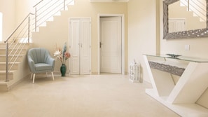 Stylish space with a staircase, seating area, and elegant decor.