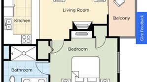 A floor plan with a living room, two bedrooms, a kitchen, two bathrooms, and a balcony.
