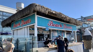 A beach food stand with a thatched roof and a sign reading "Beach Treats." - Modern Beach House Oasis w/ Private Patio (san diego)
