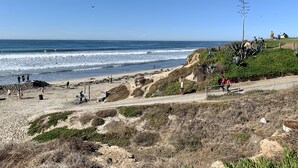 A beach with a clear sky, waves, and people. - Modern Beach House Oasis w/ Private Patio (san diego)