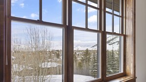A window with a view of a snowy landscape and trees. - Outpost: Grand View 5230 - Incredible Teton Views! (Jackson)
