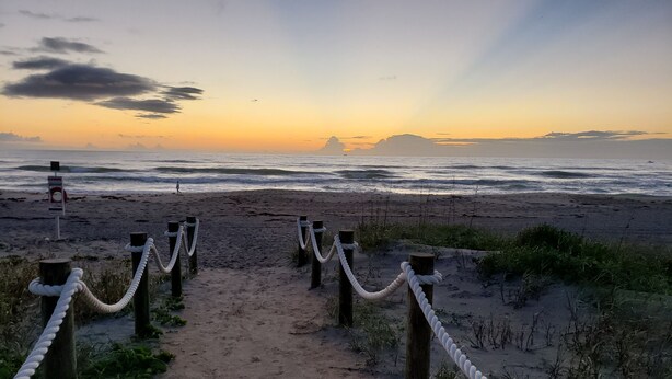 A sandy beach path with wooden posts and rope barriers leading to the ocean. - Beautiful, Private Beach House - 1 Block To The Beach - AC  3 Bedroom - Sleeps 8 (Cocoa Beach)