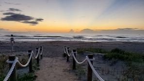 A sandy beach path with wooden posts and rope barriers leading to the ocean. - Beautiful, Private Beach House - 1 Block To The Beach - AC 3 Bedroom - Sleeps 8 (Cocoa Beach)