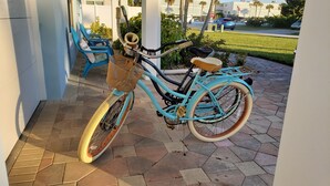 A turquoise bicycle with a wicker basket and brown seat parked on a paved patio. - Beautiful, Private Beach House - 1 Block To The Beach - AC  3 Bedroom - Sleeps 8 (Cocoa Beach)