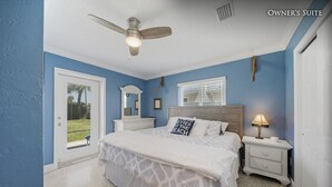 A bedroom with a bed, nightstands, a ceiling fan, and a window with blinds. - Beautiful, Private Beach House - 1 Block To The Beach - AC  3 Bedroom - Sleeps 8 (Cocoa Beach)