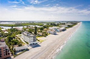 A coastal hotel with a beachfront view, multiple buildings, and a sandy beach. - Grouper Getaway on Manasota Key (Englewood)