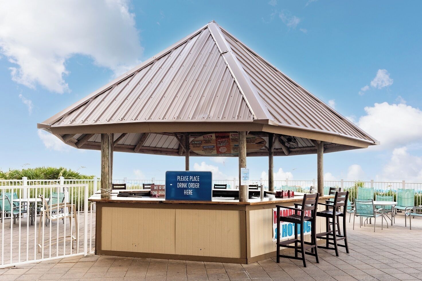 A gazebo-style structure with a sign indicating a drink order area.