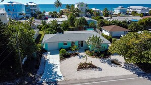 A residential area with houses, a clear view of the ocean, and a well-maintained lawn. - Tropical Oasis - Englewood Beach, FL. (Englewood)
