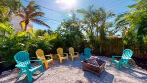 A patio area with outdoor seating and a fire pit. - Tropical Oasis - Englewood Beach, FL. (Englewood)