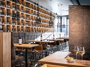 Enjoy a wine cellar dining experience with a selection of wines and comfortable seating areas.