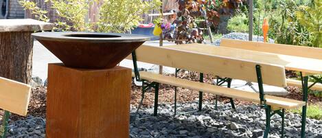 An outdoor seating area with benches and a central planter.