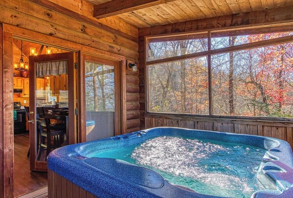 Relax in a cozy cabin with a hot tub and stunning views of the surrounding autumn foliage.