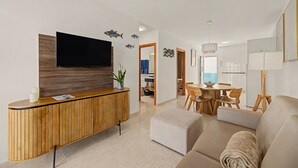 A modern living room with a flat-screen TV, wooden console, and a sofa. - Holiday Apartment “Callao Beach 6” with Sea View, Terrace & Wi-Fi (Arrieta)