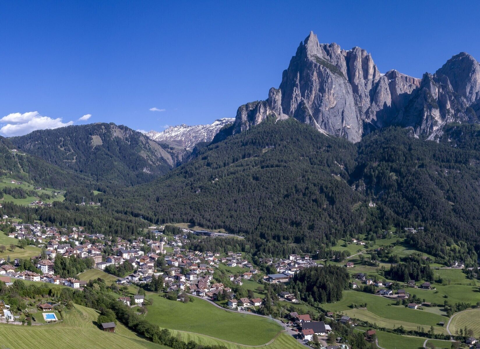 A mountainous landscape with a village nestled in the valley.