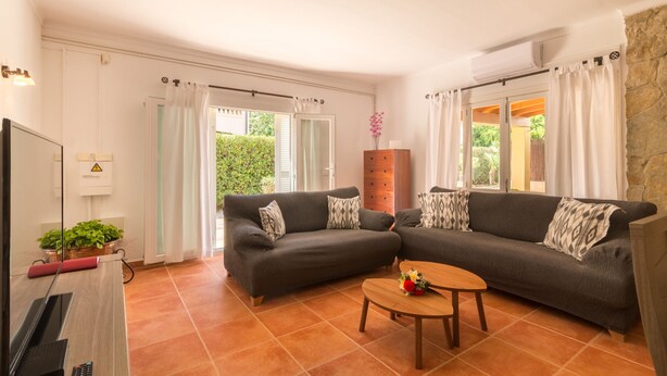 A living room with two grey sofas, a wooden coffee table, and a TV on a stand. - Holiday house with private pool only 200m to the beach, Cala Ratjada, Mallorca (Cala Ratjada)