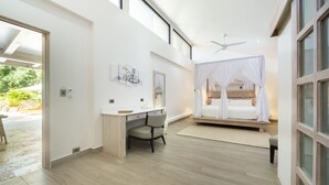 A modern bedroom with a desk, a bed with a canopy, and large windows. - Luxurious Ganesh Villa (Nicoya)