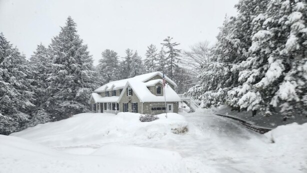 A snow-covered house with a steep driveway and snow-laden trees in the background. - Skiing, snowshoeing, snowmobile/ATV trails, hunting, hiking and kayaking (Rumford)