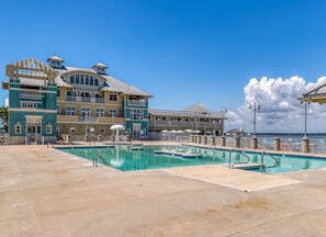 A hotel with a large pool area, multiple balconies, and a view of the sea. - Sunset Island 18 Beach Walk Lane (Ocean City)