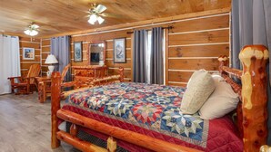 A log cabin room with a wooden bed, a wooden dresser, a chair, and a ceiling fan. - Valentine Drive Cabin 2 (Lookout Mountain)