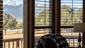 A room with a view of a mountainous landscape through a window with wooden blinds. - Rhode's Hideaway- Dog Friendly, Minutes to Salida, Close to Monarch (Salida)